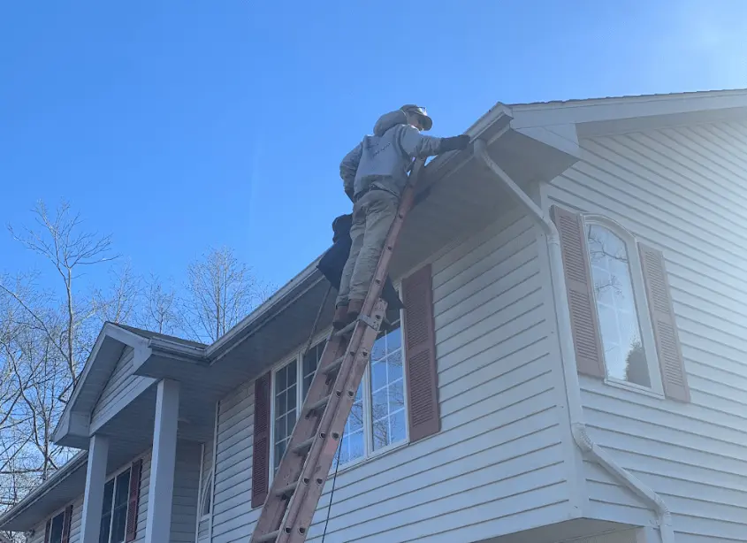 Gutter cleaning and maintenance being performed by New Franklin Power Washing in New Franklin